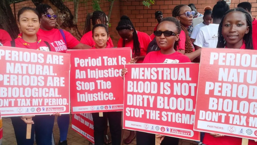 Women holding protest signs