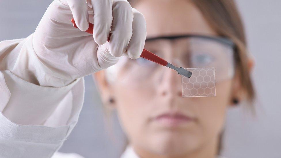 A scientist demonstrating graphene's structure