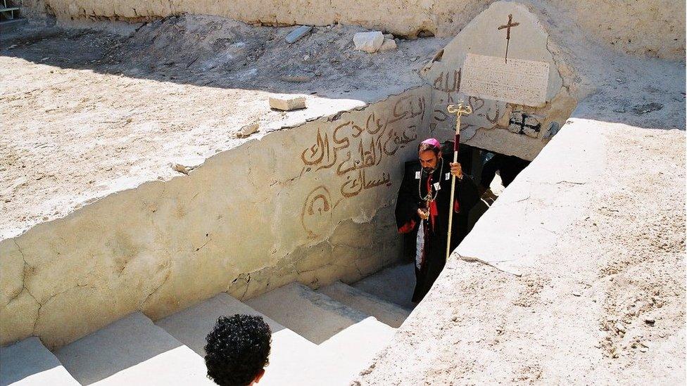 Bishop Georges leads the annual procession out of the underground tomb