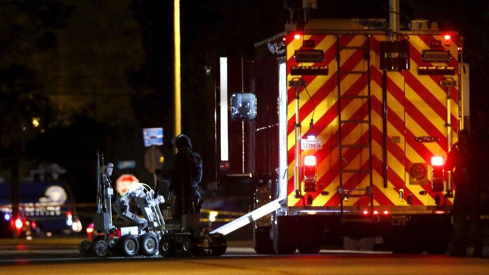 Police officers and their vehicles line the street in Redlands, California outside the house of one of the suspects in San Bernardino shooting rampage December 2, 2015