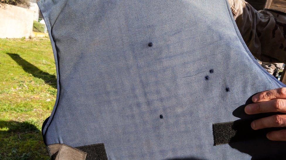 Bullet holes on a bullet proof vest