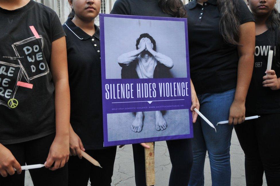 Indian students participate in a candle light vigil to protest against the rape of an eight-year-old girl in Kashmir.