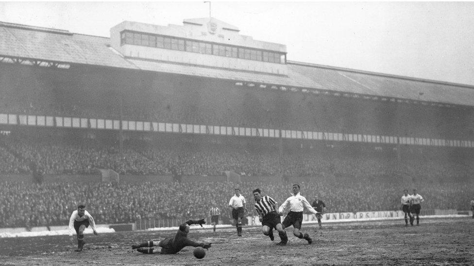 18th January 1936: Spurs goalkeeper, Taylor, deflects a goal bound shot with his finger tips from Sheffield player, Dodds, as Tottenham Hotspur play Sheffield United at White Hart Lane.