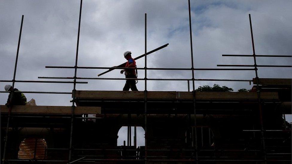 Builder assembling scaffolding