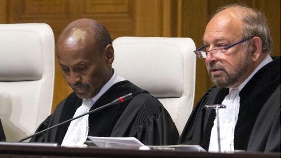 Ronny Abraham (right) sits in the court at the Hague on September 24, 2015