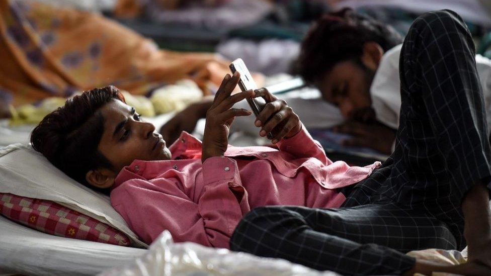 Young man looking at mobile phone in India