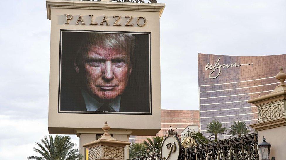 The image of Republican presidential hopeful Donald Trump is seen on an electronic display announcing the upcoming Republican presidential debate, hosted by CNN, December 14, 2015