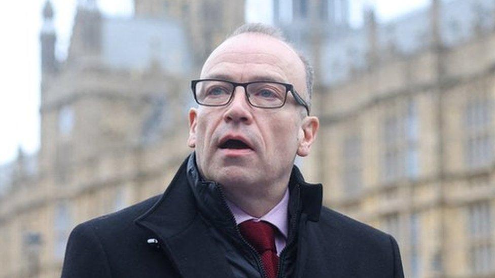 British Secretary of State for Northern Ireland Chris Heaton-Harris delivers a statement to media members near the Houses of Parliament is expected to update parliament on the deal