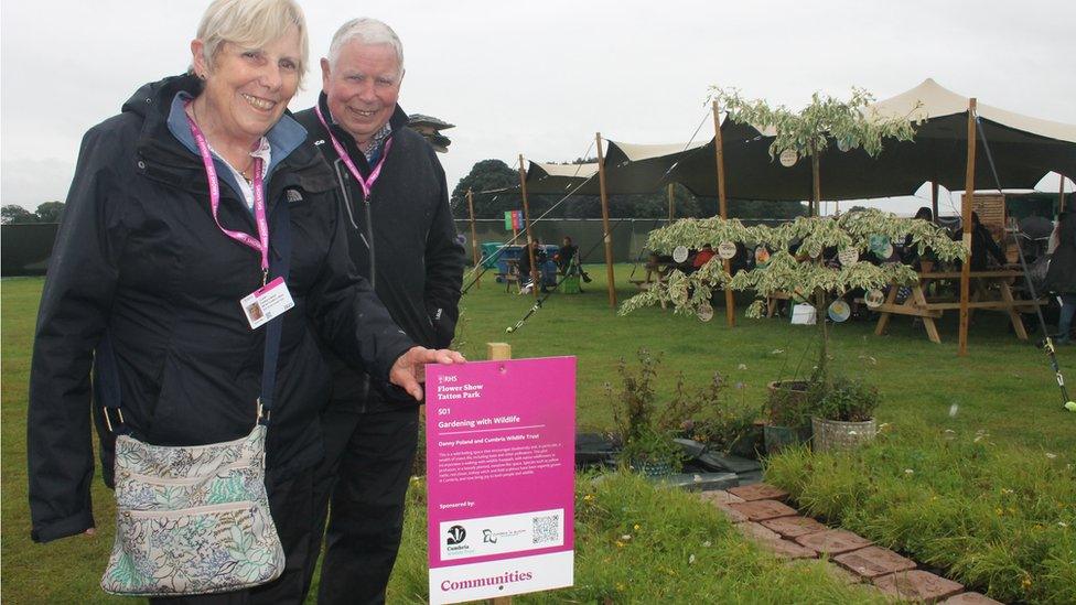 Chair of Cumbria in Bloom Ronnie Auld with Liz Auld at the Cumbria in Bloom Garden at RHS Tatton Park Flower Show 2023.