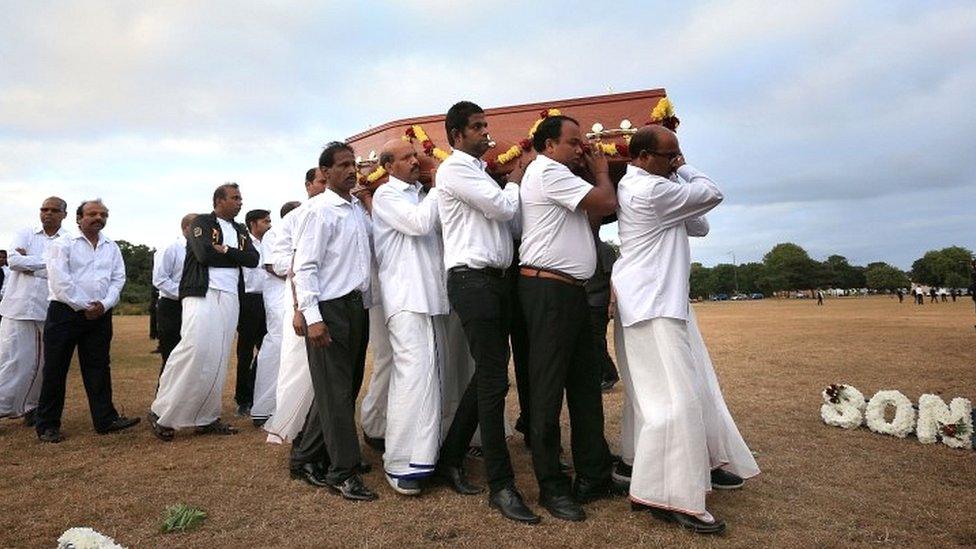 The coffin of Gurushanth Srithavarajah is carried to into marquee tents on Winn's Common