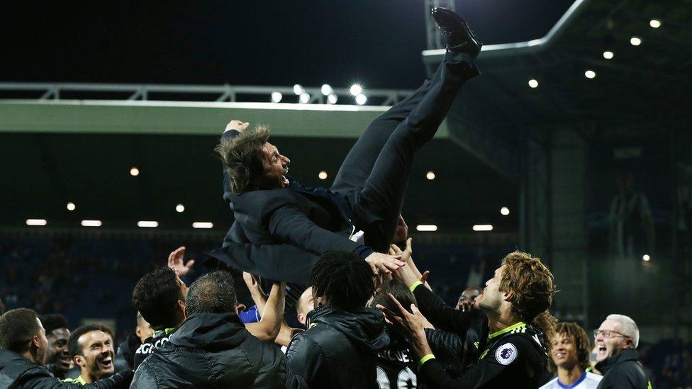 Antonio Conte being thrown in the air by Chelsea players