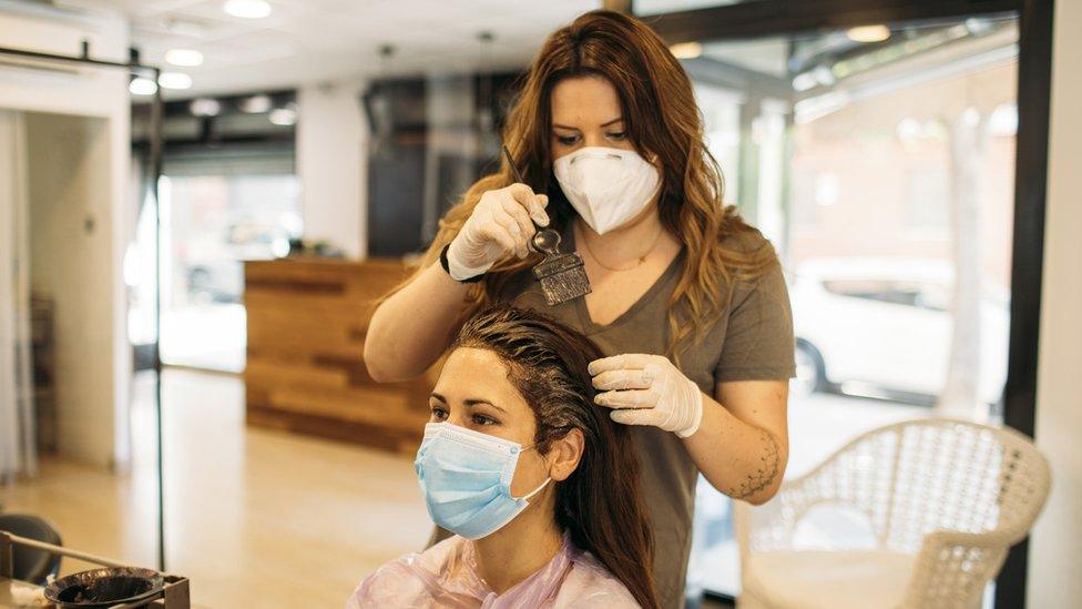 Woman getting her hair coloured in a salon