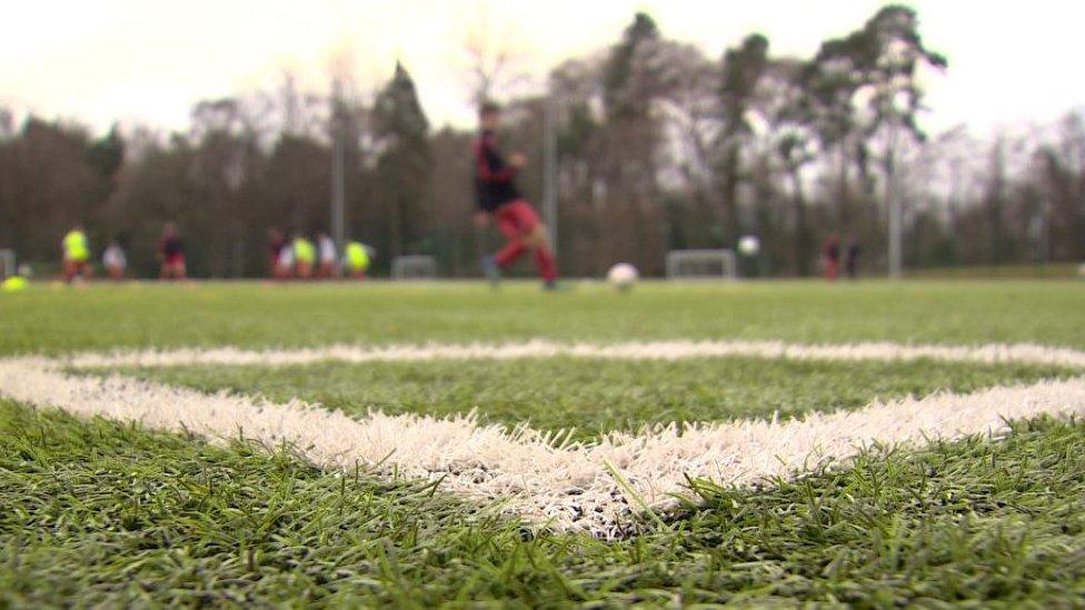 Players in distance on pitch