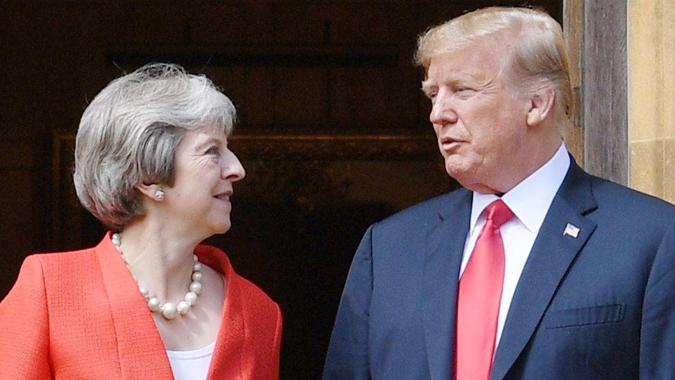 US President Donald Trump stands with Prime Minister Theresa May on the doorstep at Chequers