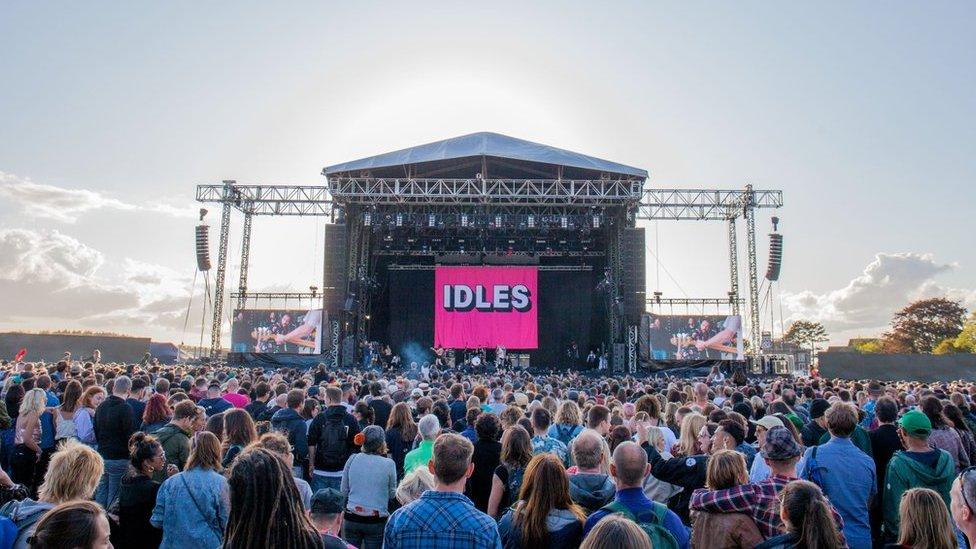 Music stage with thousands of fans watching