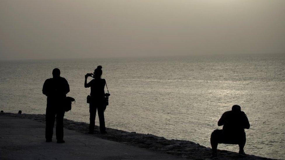 Photographers shoot pictures at the colonial-era fortress "El Morro Cabana" as dust carried by winds from the Sahara desert shrouds Havana, Cuba, June 24, 2020.