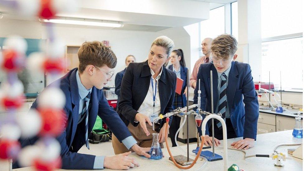 Teacher with pupils in science lab