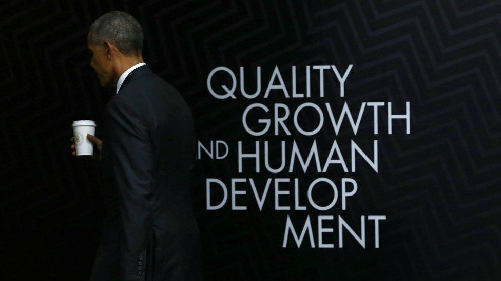 US President Barack Obama leaves the stage after holding a press conference at the conclusion of the APEC Summit in Lima, Peru. Behind him the words "quality growth and human development". 20 November 2016.