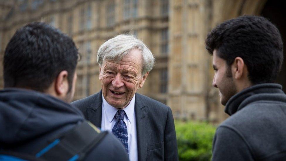 Lord Dubs speaks to two child refugees from Syria on College Green on 25 April