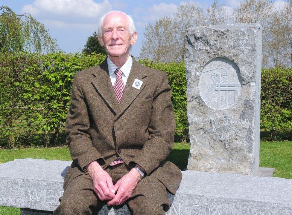 Former Bevin Boy Harry Parkes poses for a portrait next to the Memorial to the Wartime Bevin Boys, which he designed and campaigned for