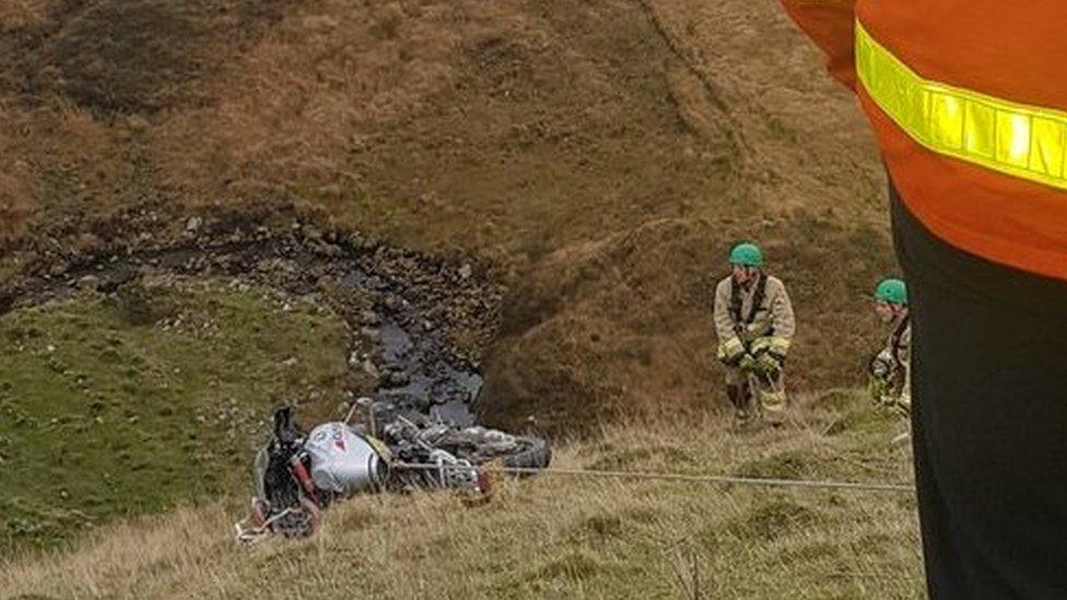 Rescue services travel down the embankment