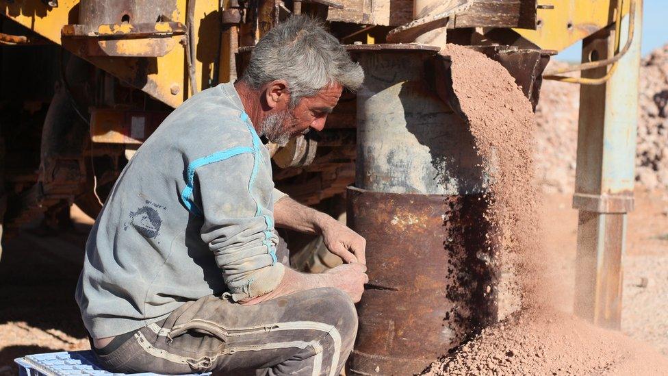 Richard Saunders use a 40-foot drill on the Shell Patch Reserve, an opal field in South Australia.