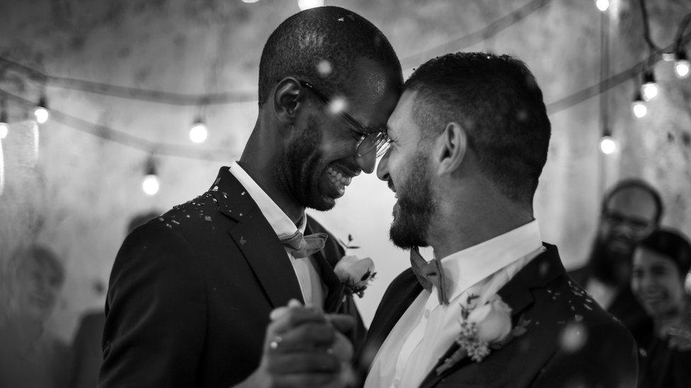 Gay men dancing at wedding