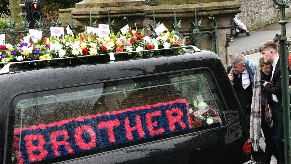 Morgan Barnard's parents and brother walk behind the hearse carrying his coffin