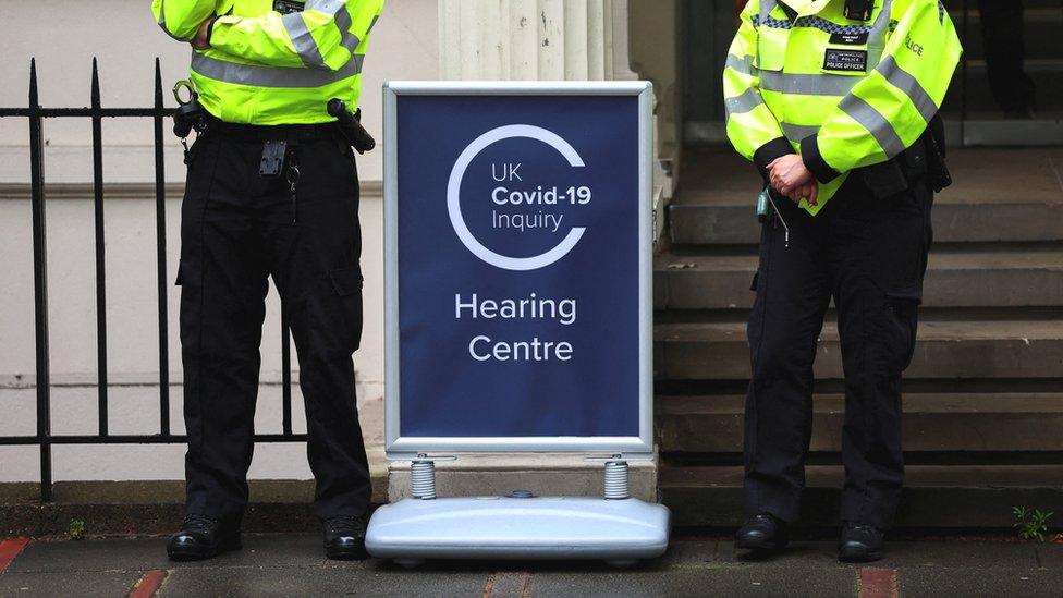 Police officers outside the entrance to the Covid inquiry