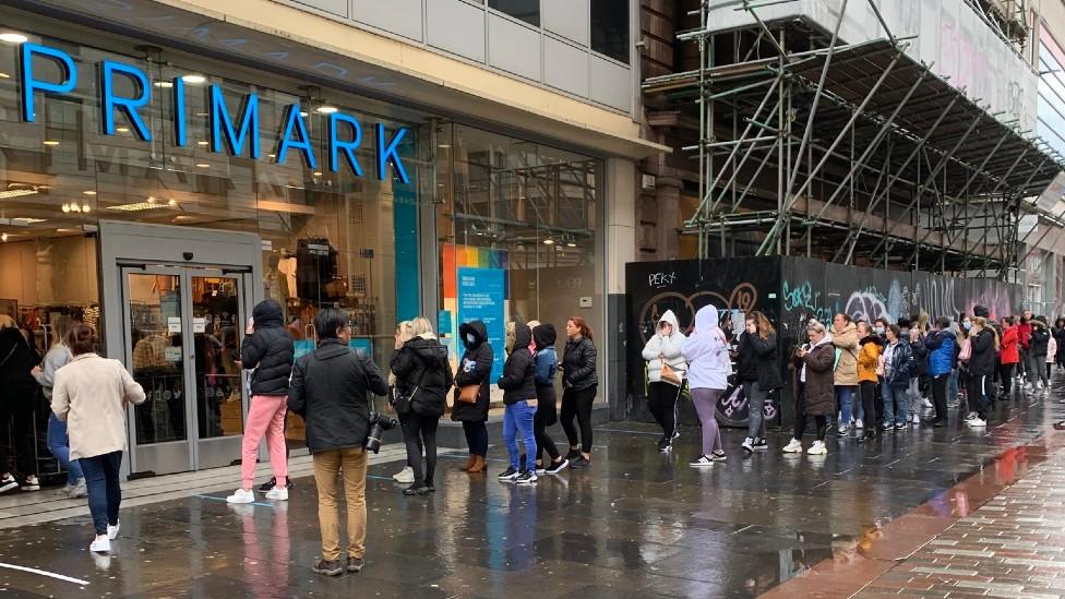 Primark shoppers queue in the rain