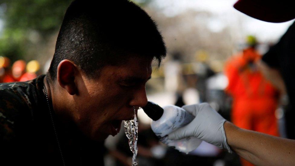 Rescue worker has his face washed, 6 June 2018