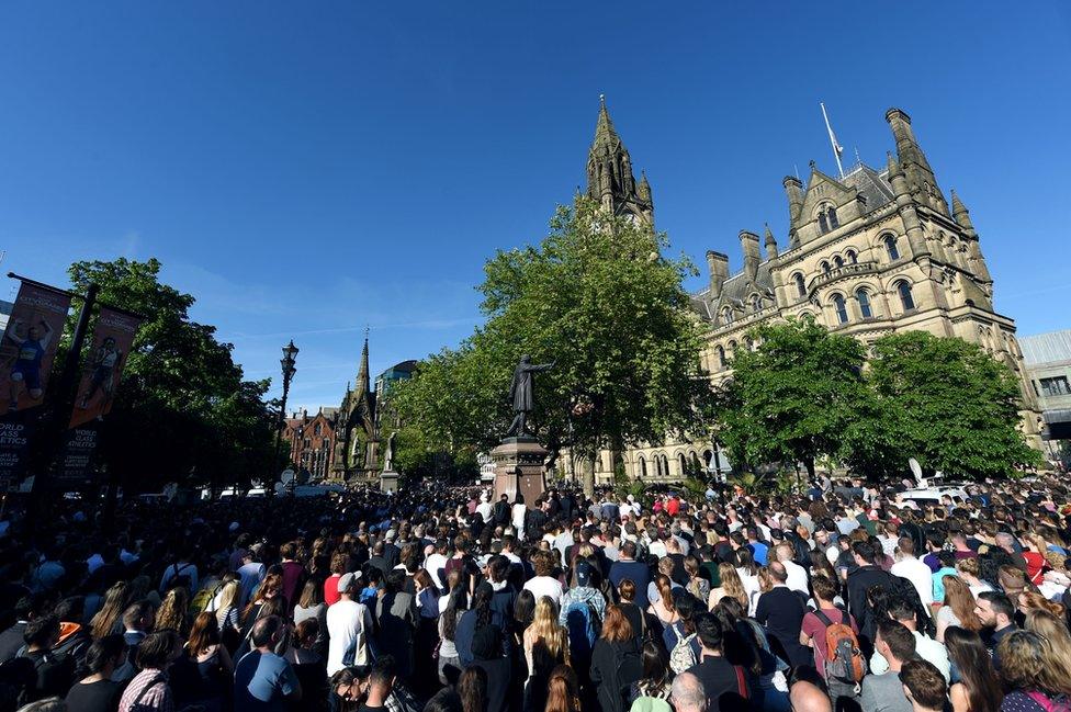 People gather for a vigil in Albert Square outside Manchester Town Hall