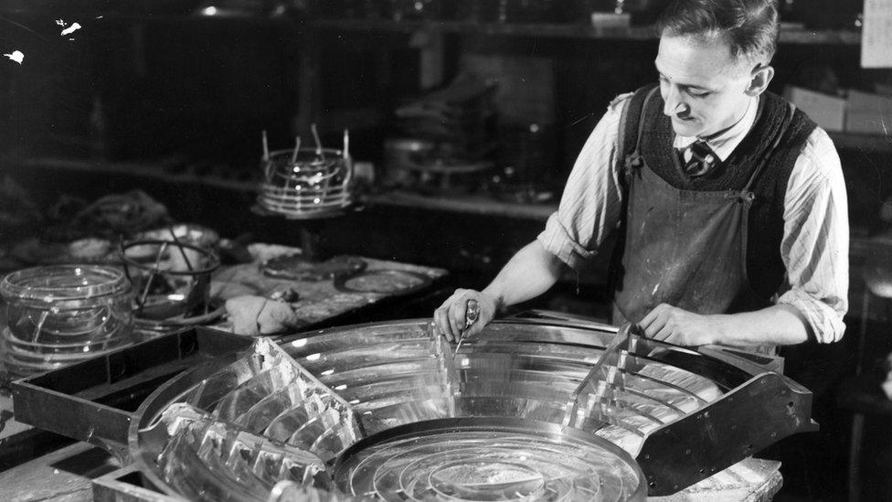 A worker making the glass prisms for the lighthouses