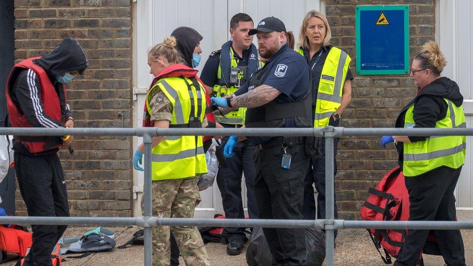 Military and Border Force with migrants at Dover