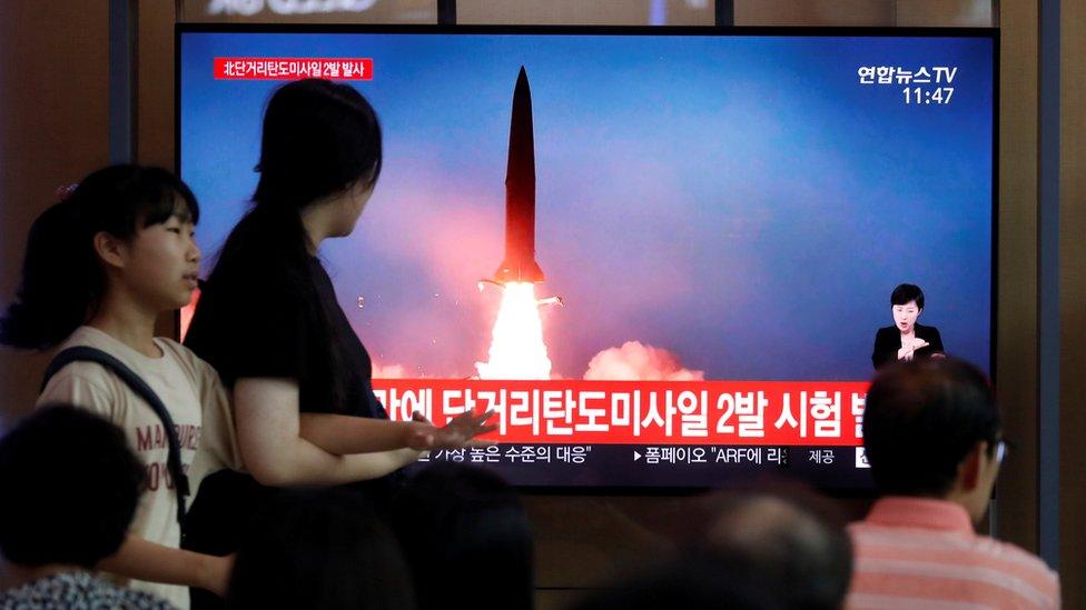 People watch a television showing a file picture of a North Korean missile for a news report on North Korea firing short-range ballistic missiles, in Seoul, South Korea, July 31, 2019.