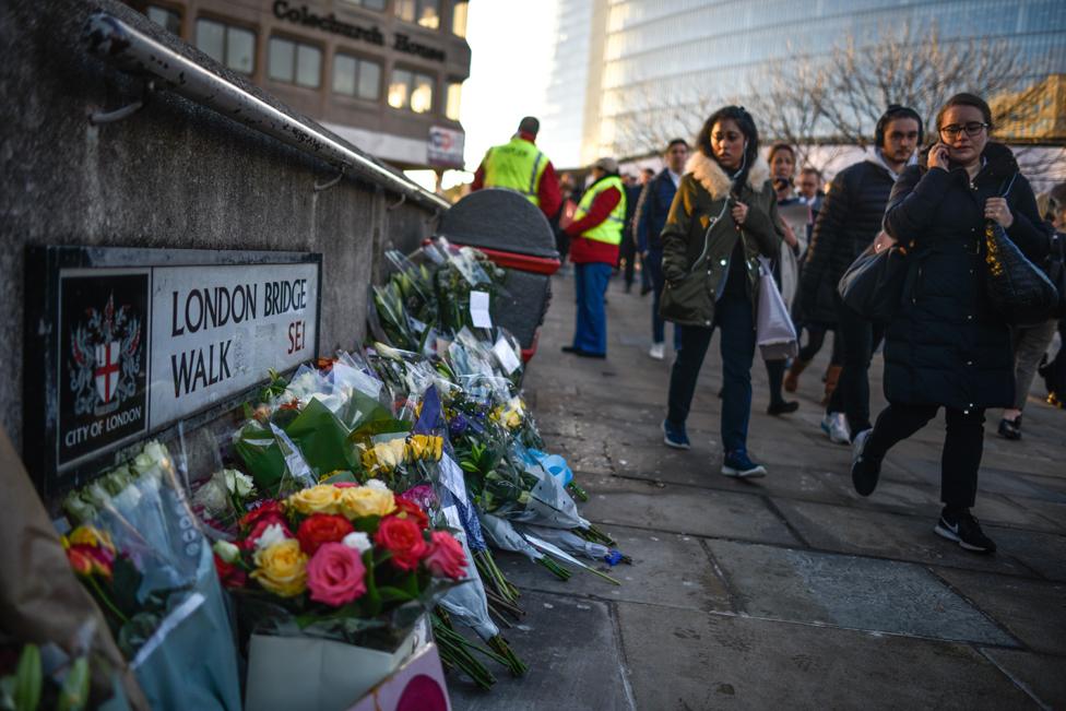 Floral tributes are left near London Bridge for Jack Merritt and Saskia Jones