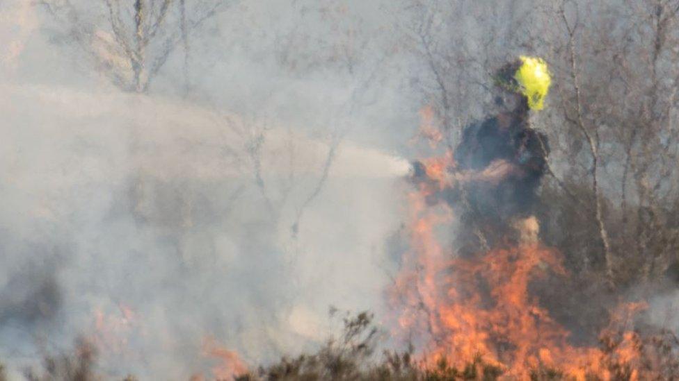 A firefighter with a hose