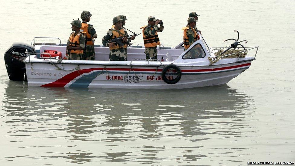 Indian Border Security Force (BSF) soldiers on a boat patrol on the Chenab river near the India-Pakistan international border