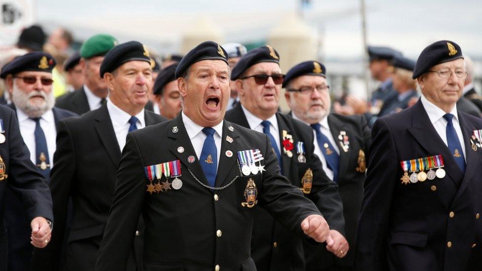 Military veterans march at an Armed Forces Day event in Liverpool