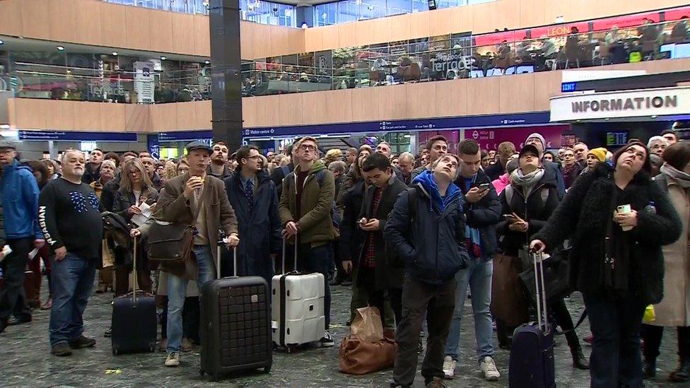 A crowd of passengers at London Euston