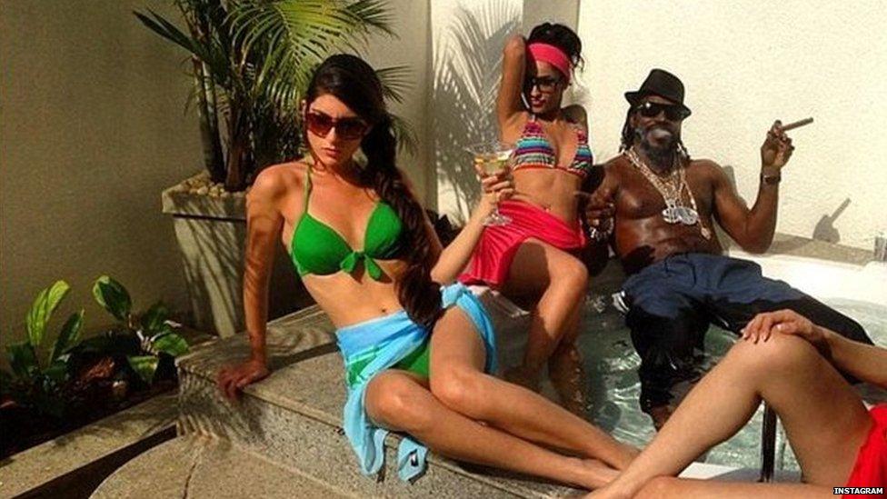 Sitting around his jacuzzi with three women