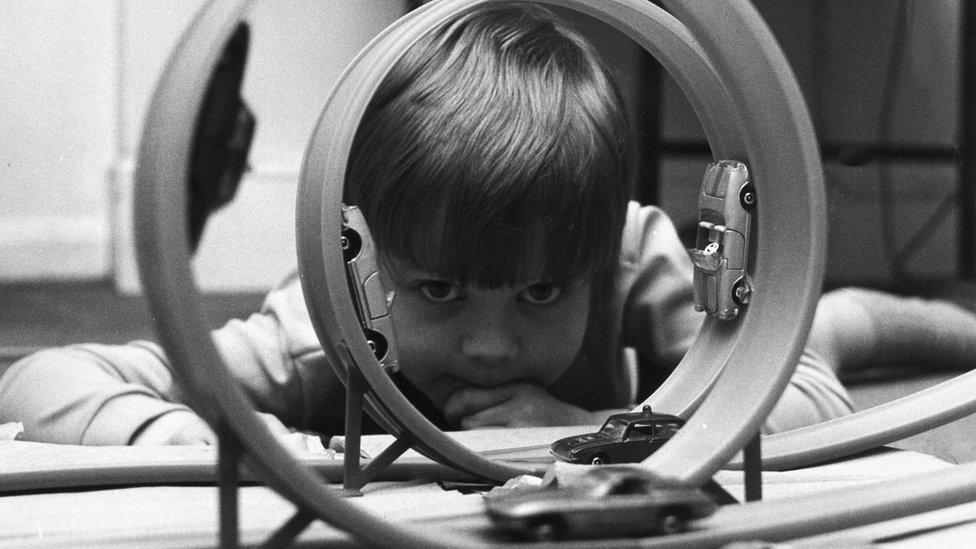 Child playing with cars