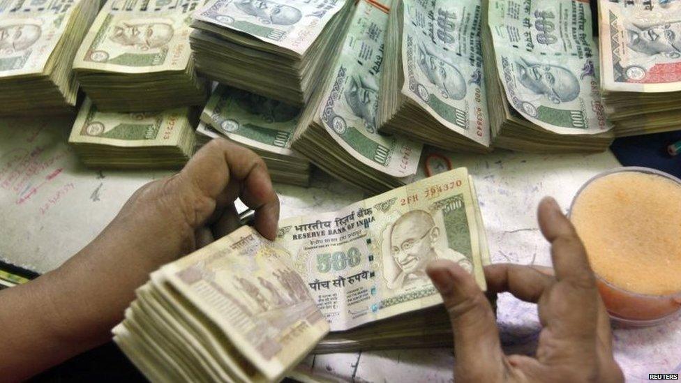 An employee counts Indian currency notes at a cash counter inside a bank in Kolkata June 18, 2012.