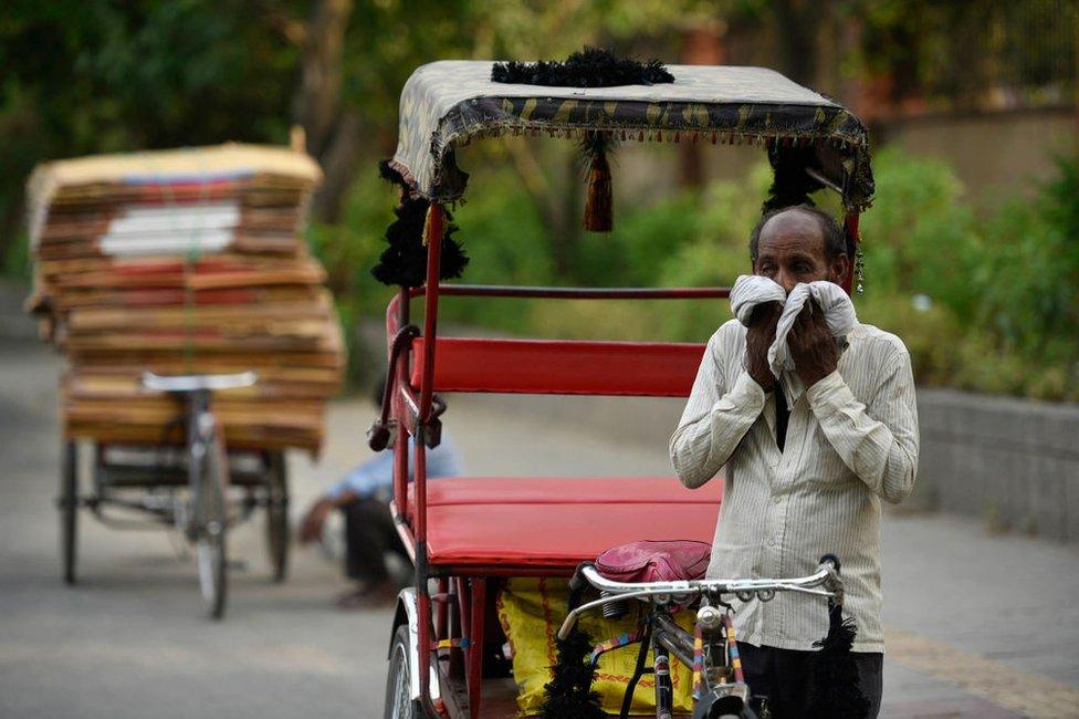 A rickshaw puller wipes his face with a cloth on a hot summer day, as temperatures in the capital reach 45 degree Celsius, on May 31, 2019 in New Delhi, India.