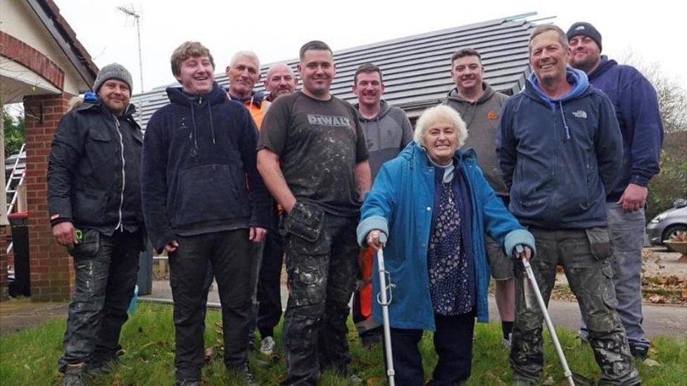 Ann Rowlands (fourth from right) with traders and builders who helped her