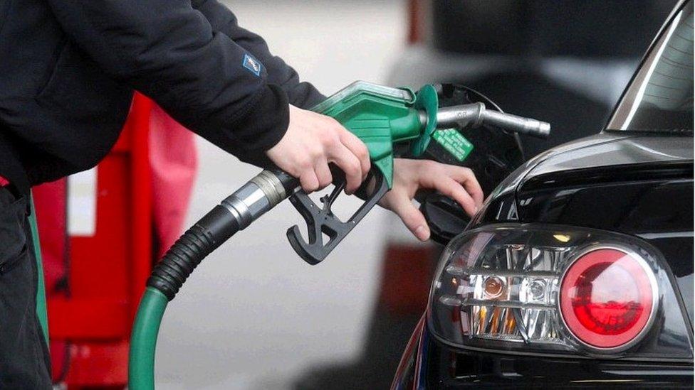 Someone filling up a car at a petrol station