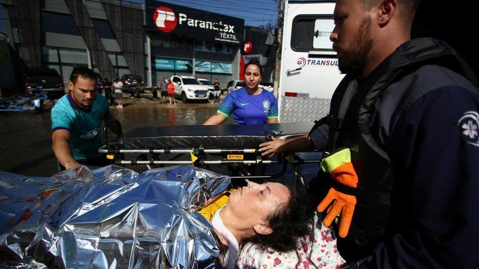 Rescue workers evacuate a flood victim in Porto Alegre, Rio Grande do Sul state, Brazil, May 5, 2024