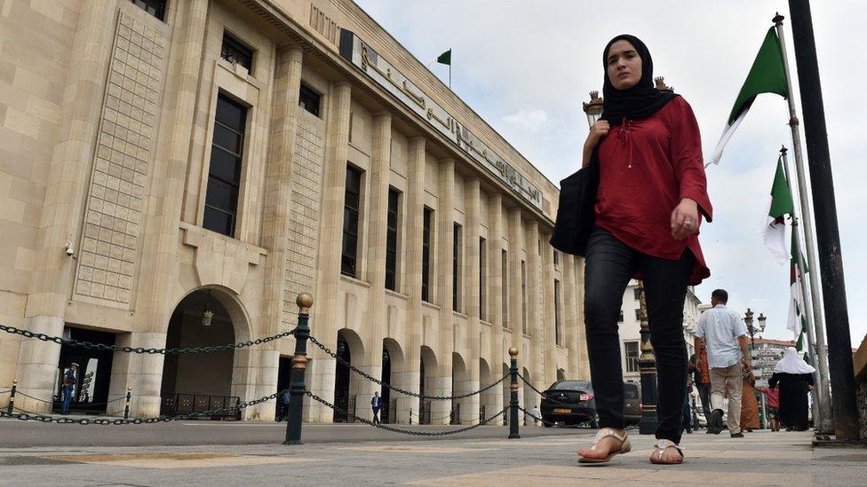 Woman walking past the exterior of the National People's Congress (NPC) in Algiers on 23 May, 2017