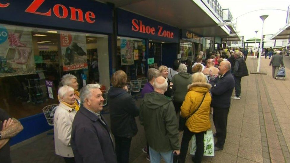 People queuing outside Thomas Cook pop-up shop