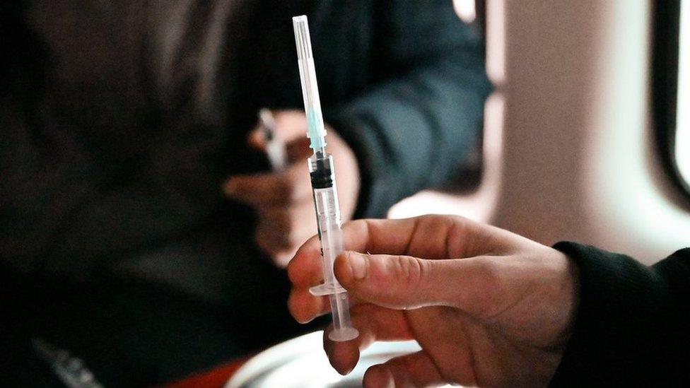 Man holding a needle inside a "safe consumption" van in Glasgow